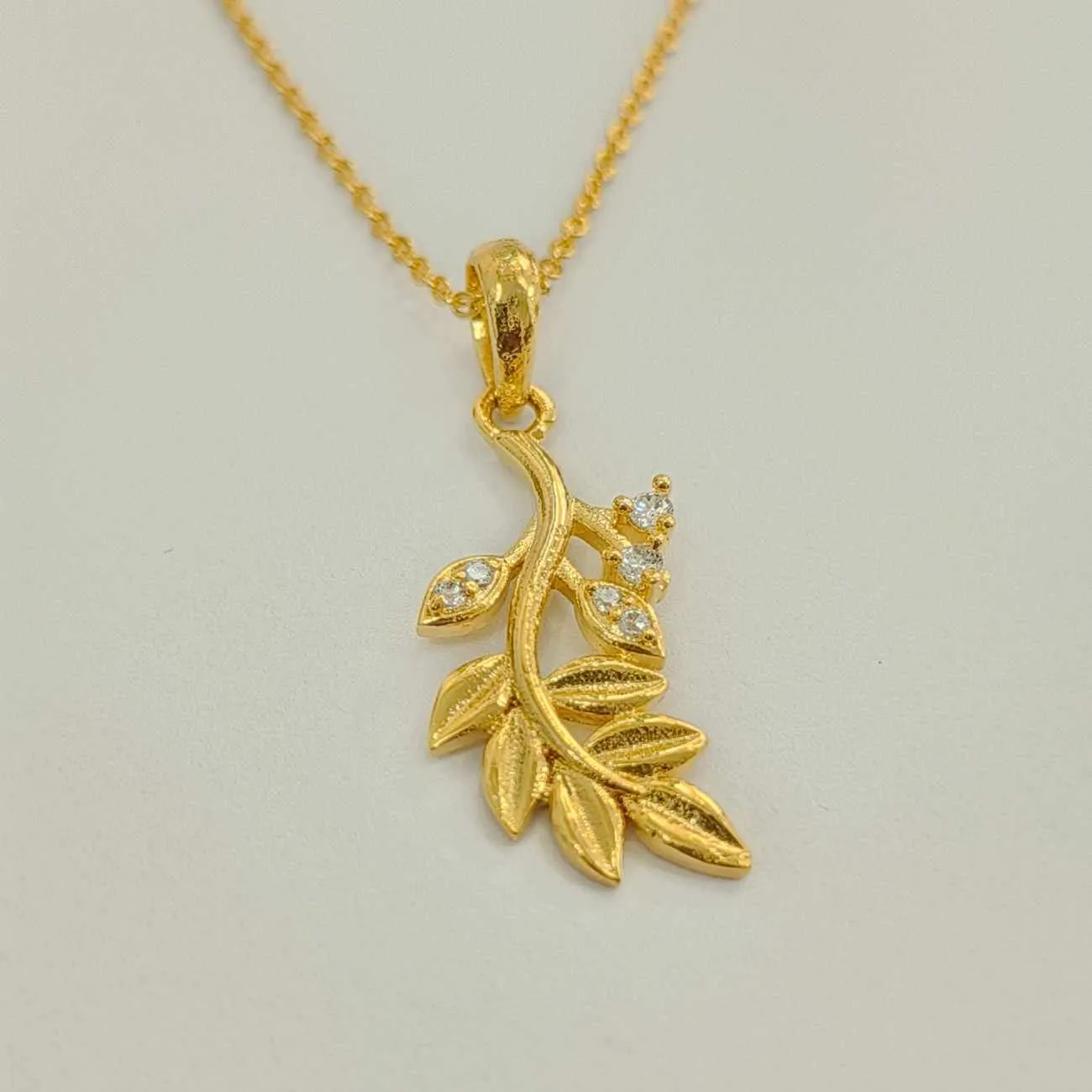 Nimoraa metallic and diamond studded leaf pendnat set
