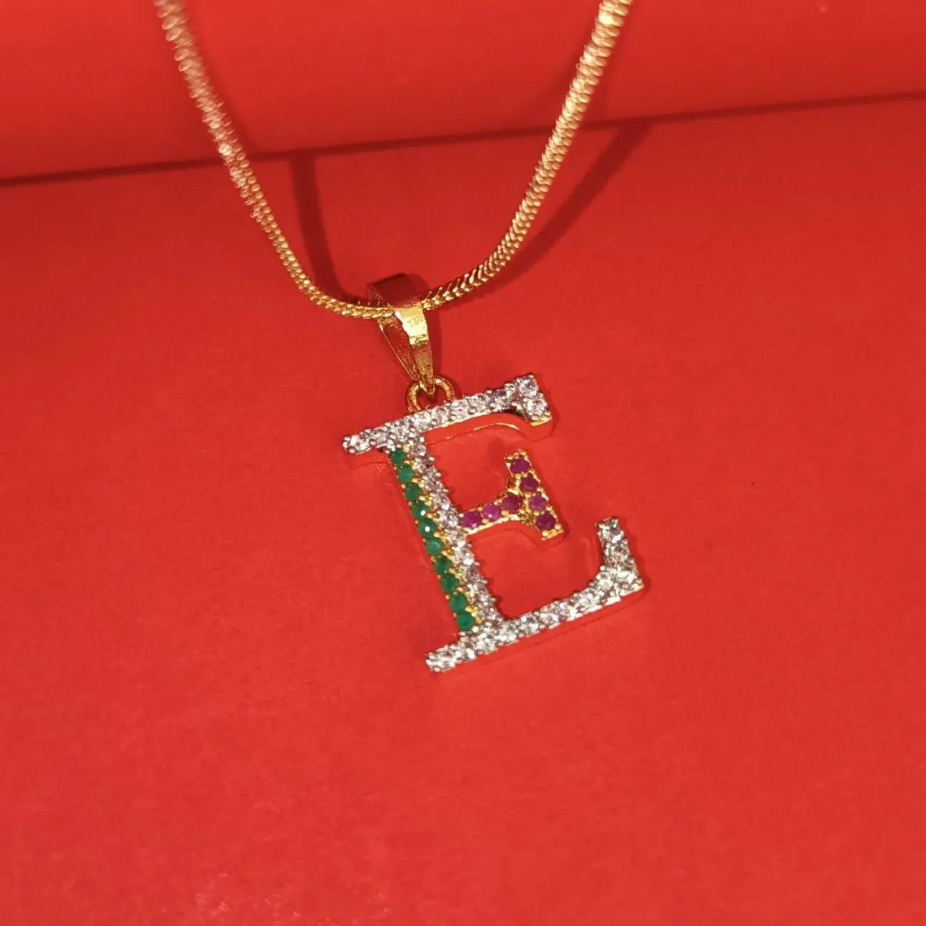 Nimoraa E Initial Gold Plated Pendant Chain with Red & Green Stones